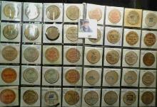 (40) various Wooden Nickels from Iowa in a pair of plastic pages.