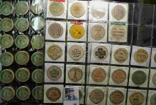 (52) various Wooden Nickels from Iowa in a pair of plastic pages.