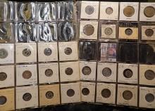 (28) Iowa Tokens in a pair of twenty pocket plasitic pages. Includes two different Oskaloosa, Iowa t