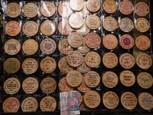 (40) Nebraska Wooden Nickels in a pair of plastic pages.