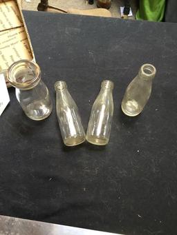 group of three baby bottles, one cream bottle