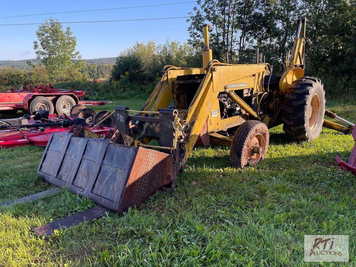 International 3414 diesel backhoe with forks and bucket