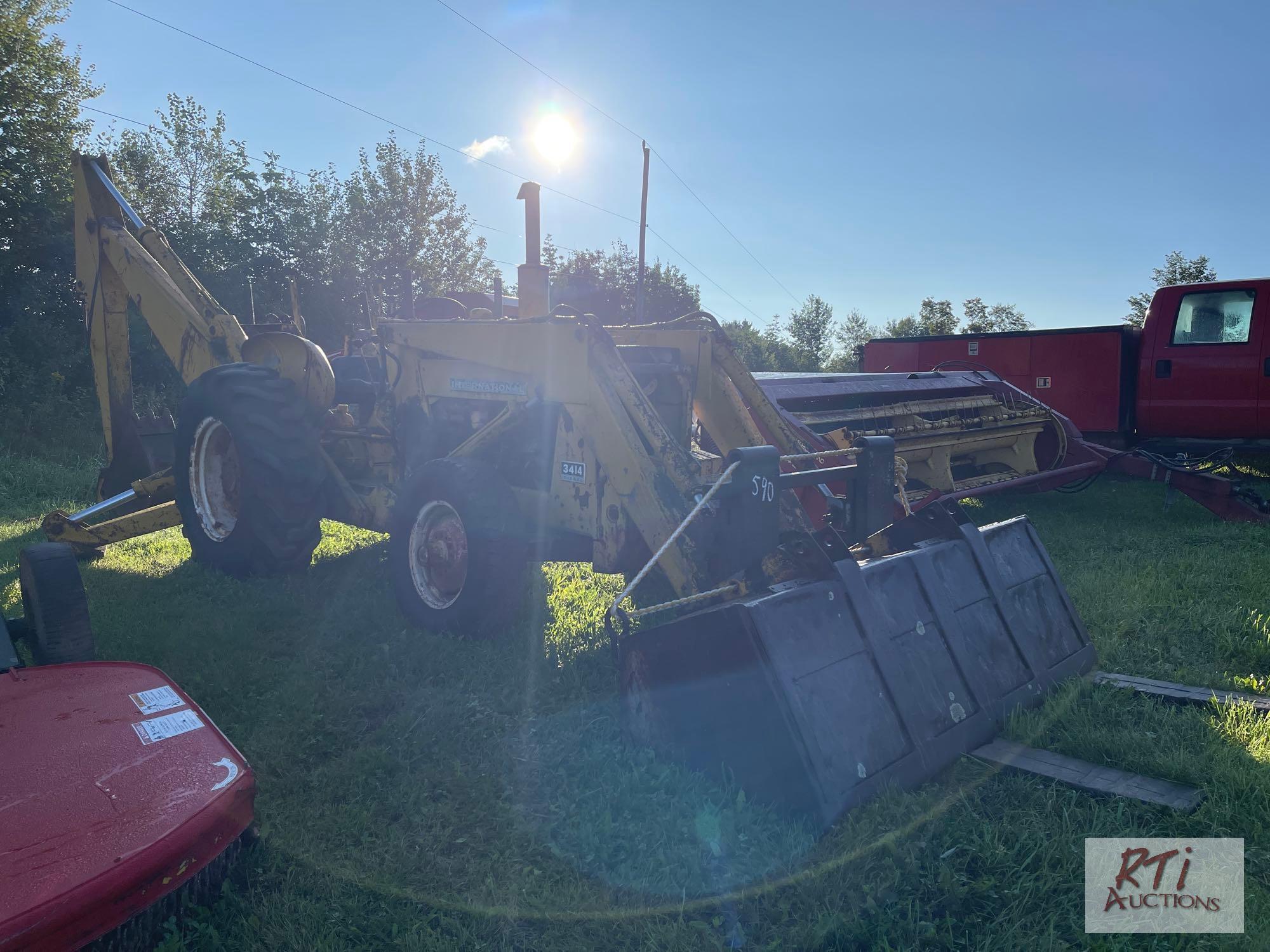 International 3414 diesel backhoe with forks and bucket