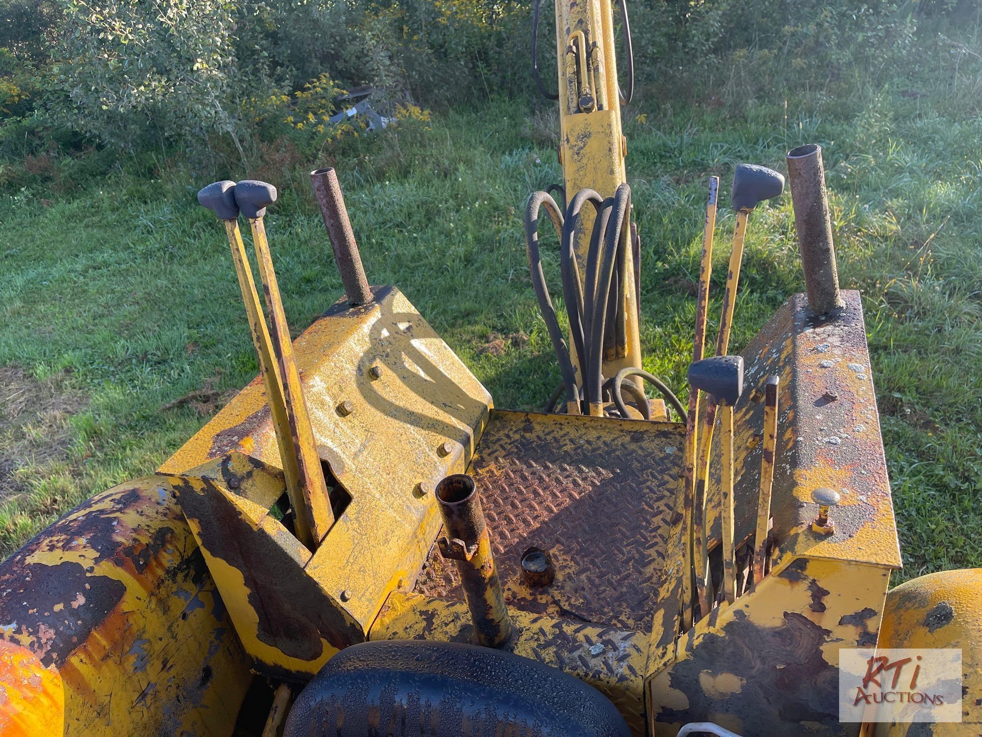 International 3414 diesel backhoe with forks and bucket