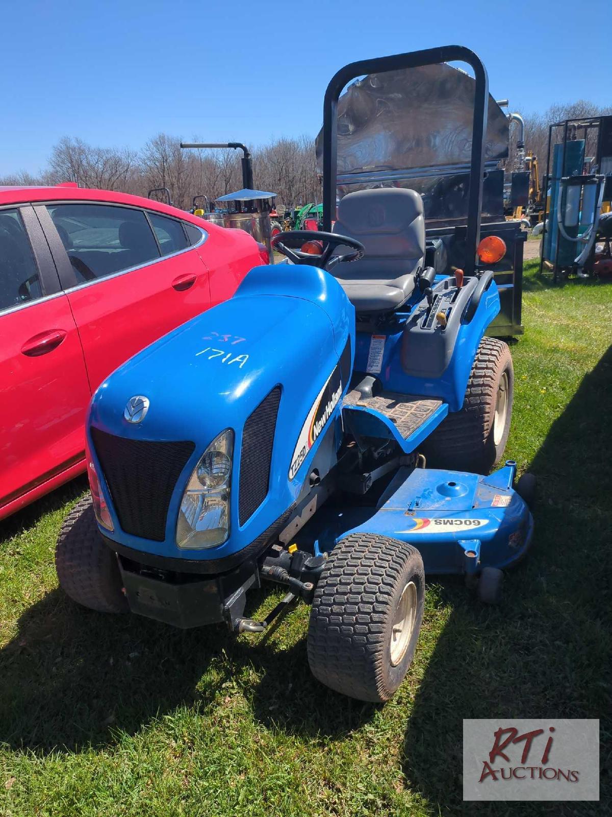 New Holland TZ25DA compact tractor, 60in belly mower, lift arms, PTO, HST, high/low range, 4WD, 210