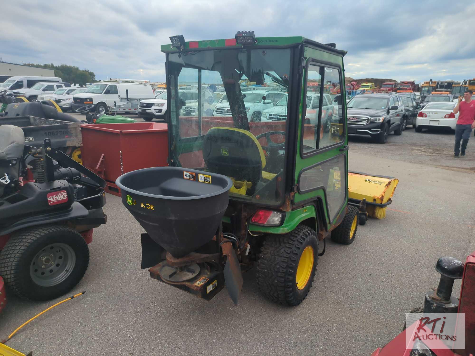 John Deere X758 lawn tractor, 4WD, 52in front hydraulic sweeper, rear spin spreader, Curtis cab, 574