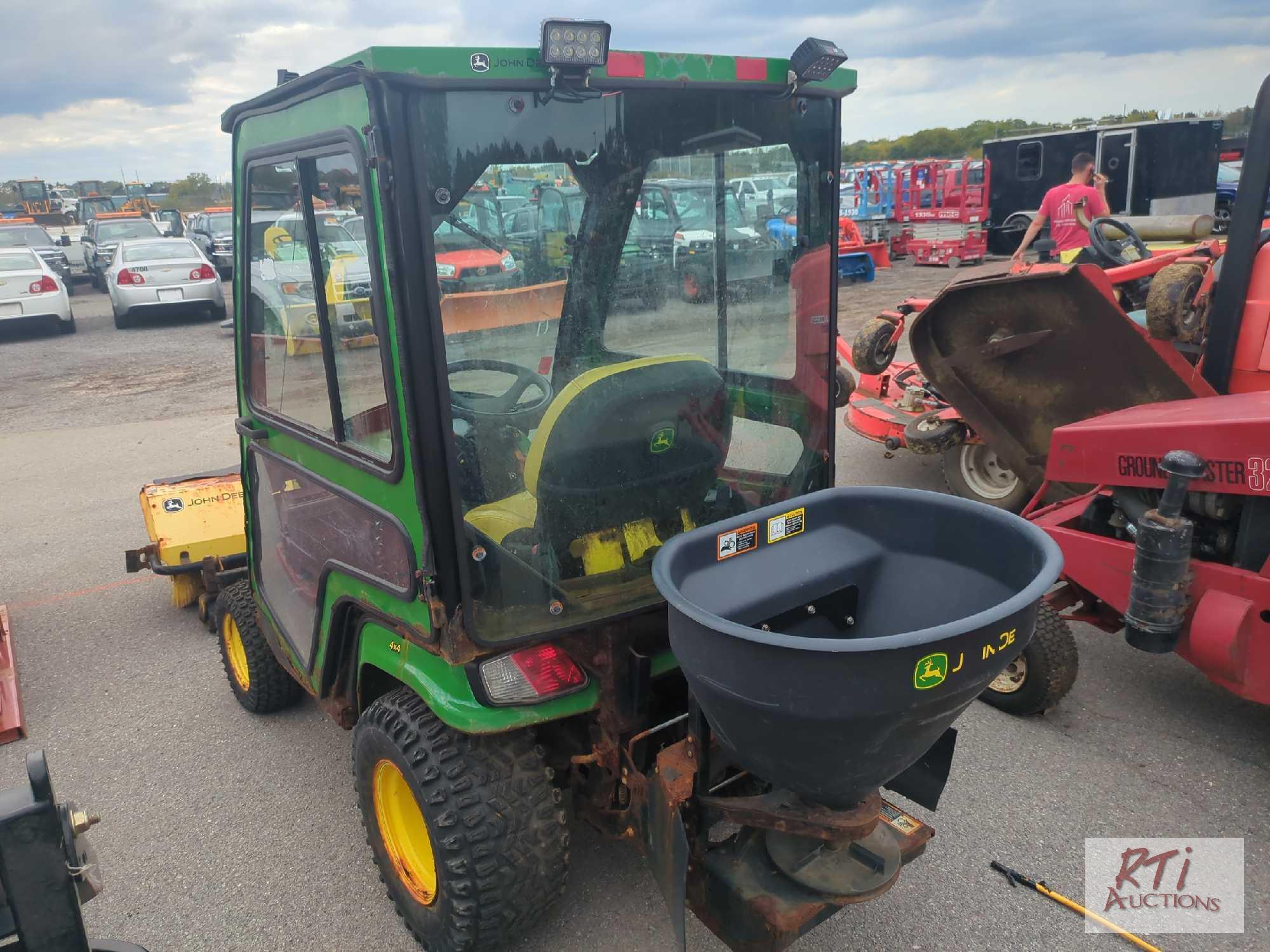 John Deere X758 lawn tractor, 4WD, 52in front hydraulic sweeper, rear spin spreader, Curtis cab, 574