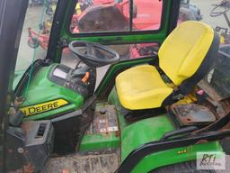 John Deere X758 lawn tractor, 4WD, 52in front hydraulic sweeper, rear spin spreader, Curtis cab, 574