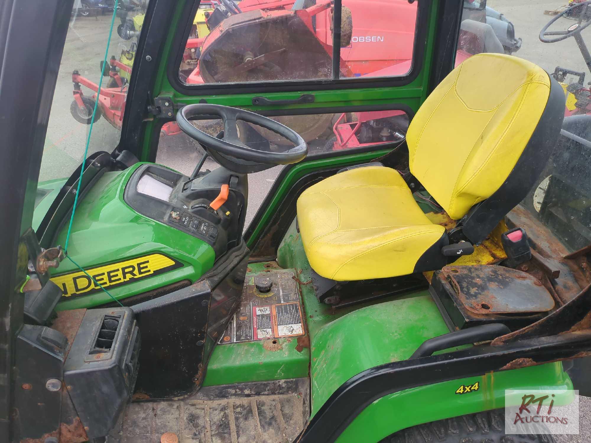 John Deere X758 lawn tractor, 4WD, 52in front hydraulic sweeper, rear spin spreader, Curtis cab, 574