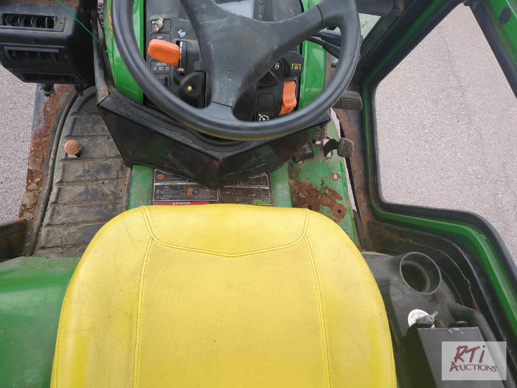 John Deere X758 lawn tractor, 4WD, 52in front hydraulic sweeper, rear spin spreader, Curtis cab, 574