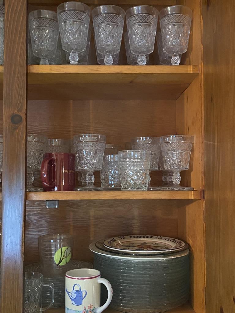 FOUR CABINETS TO THE LEFT OF THE SINK