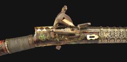 (A) AN ATTRACTIVE AND HIGHLY DECORATED CAUCASIAN MIQUELET LOCK RIFLE.