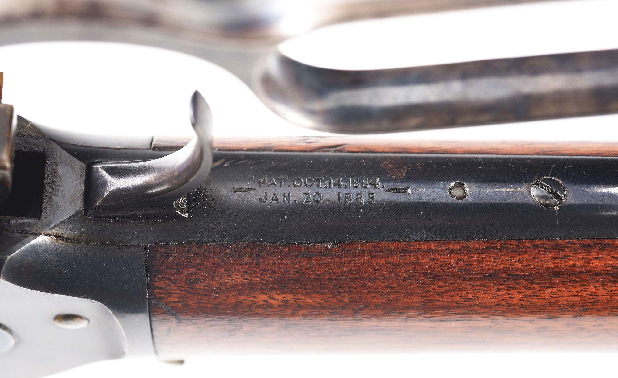 (C) WINCHESTER MODEL 1886 LEVER ACTION RIFLE.