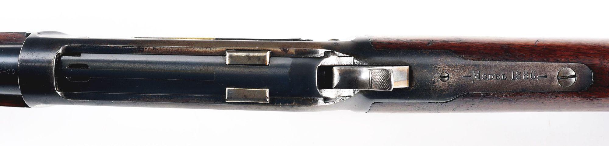 (C) WINCHESTER MODEL 1886 LEVER ACTION RIFLE.