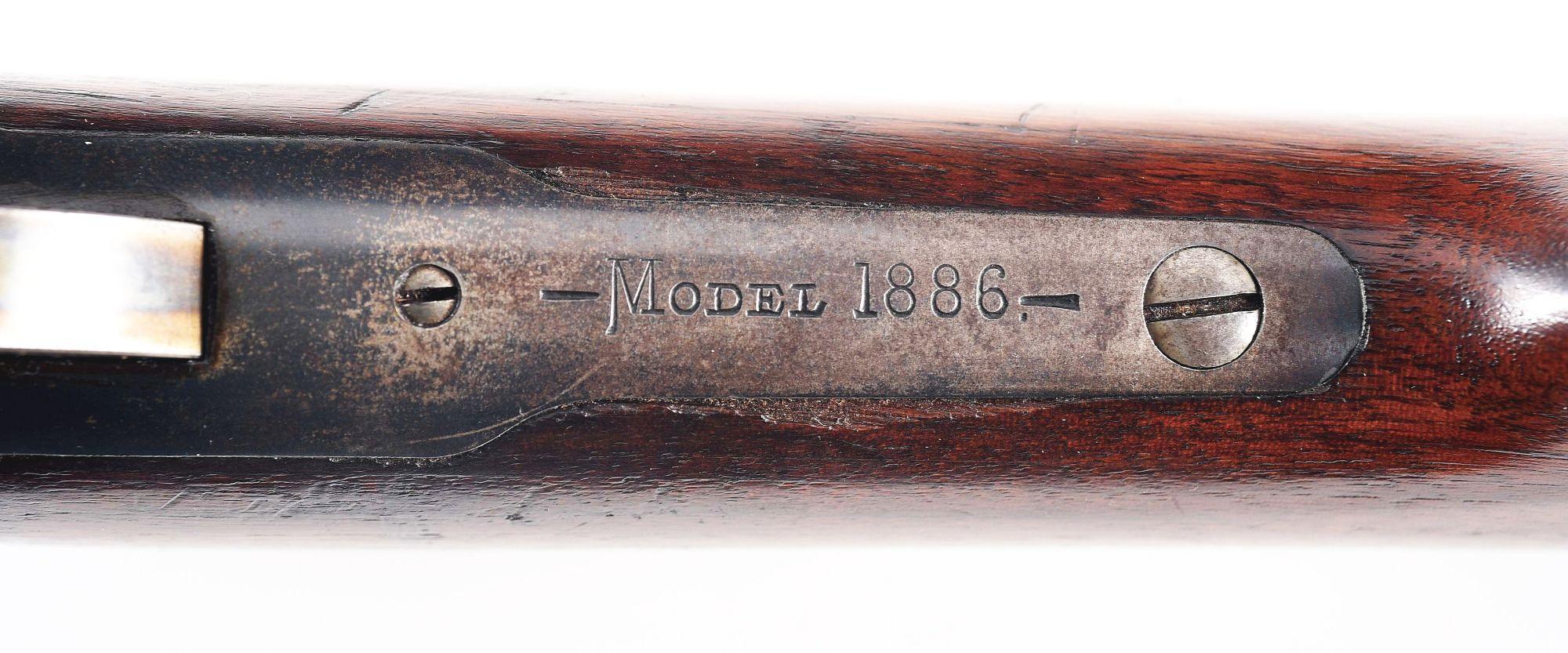 (C) WINCHESTER MODEL 1886 LEVER ACTION RIFLE.