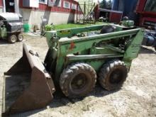 Owatonna 330 skid loader, Onan motor, 46" bucket, has a cage, cage is presently off machine