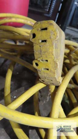 Heavy duty yellow extension cord with three outlet end