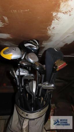 Gray golf bag with clubs