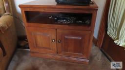 Small Silvania television with oak finish flat screen TV stand