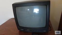 Small Silvania television with oak finish flat screen TV stand