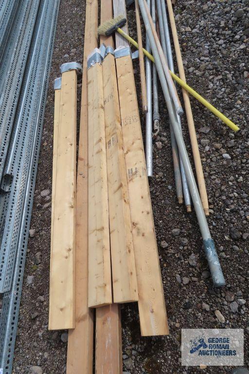 Lot of painters poles, drywall sanders, and 2x4s