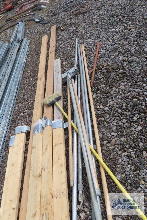 Lot of painters poles, drywall sanders, and 2x4s