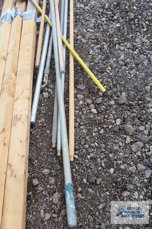 Lot of painters poles, drywall sanders, and 2x4s