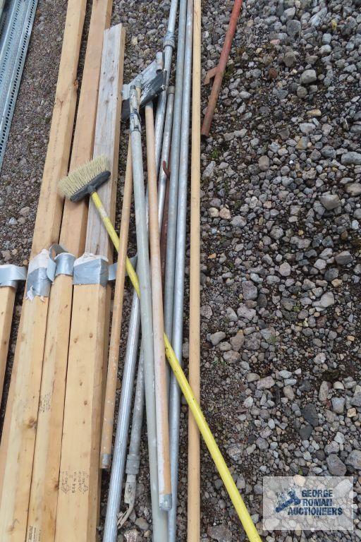 Lot of painters poles, drywall sanders, and 2x4s