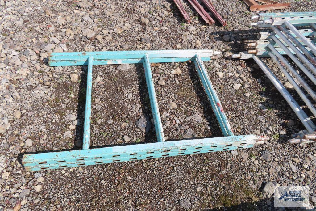 Lot of green roll about scaffolding pieces with boards