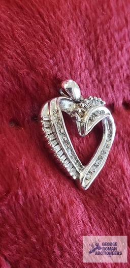 Silver colored and clear gemstone heart-shaped pendant, marked 10K, approximate total weight is 1.78