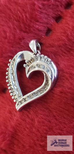 Silver colored and clear gemstone heart-shaped pendant, marked 10K, approximate total weight is 1.78