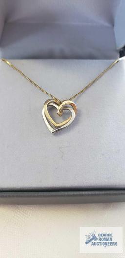 Gold and silver colored heart pendant, marked 14K on gold colored chain, marked 14K Italy,