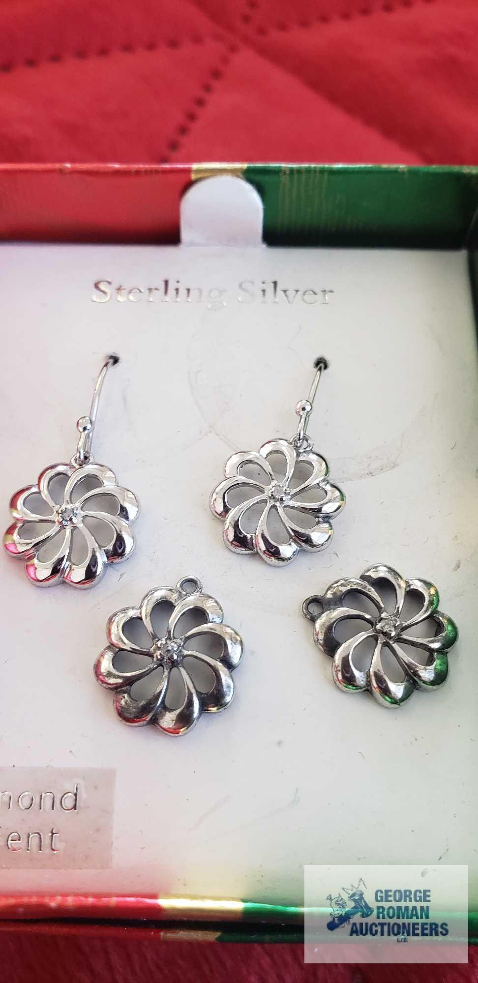 Silver colored dangle earrings, marked 925, with clear gemstone chip and two extra dangles. Box
