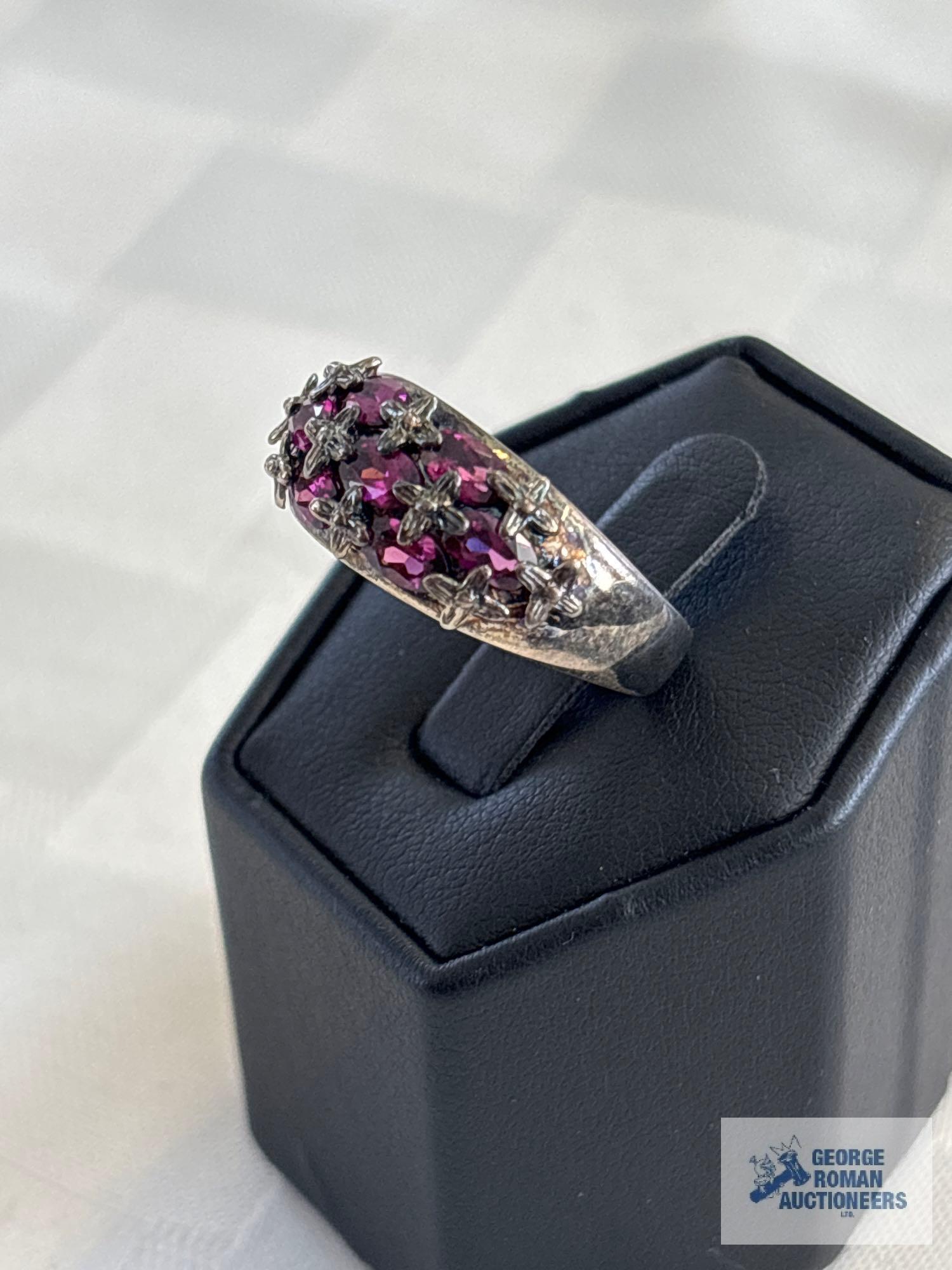 Silver colored ring with purple gemstones, marked 925, approximate total weight is 5.02 G