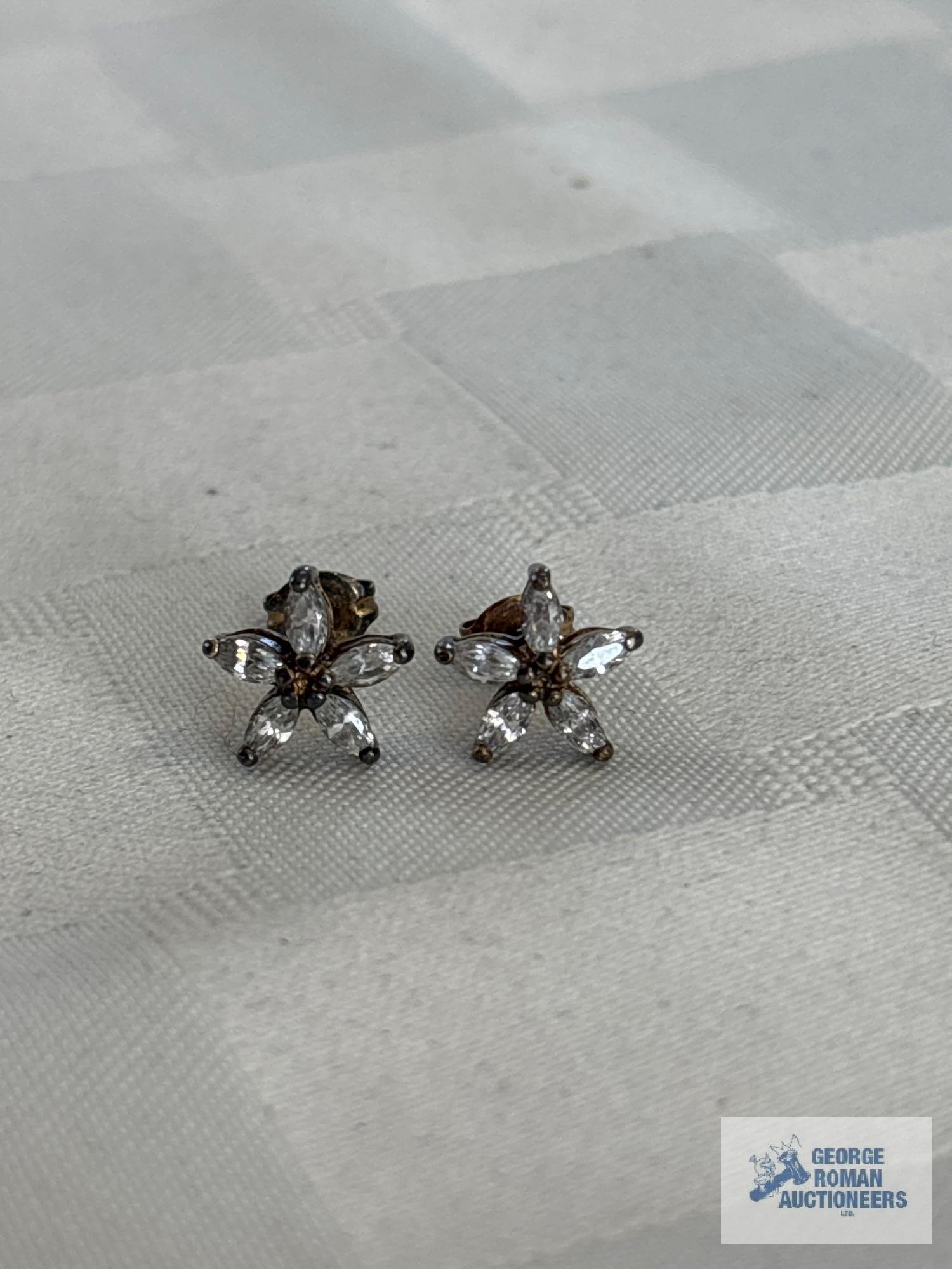 Silver colored flower shaped earrings with clear gemstones, marked 925 CZ