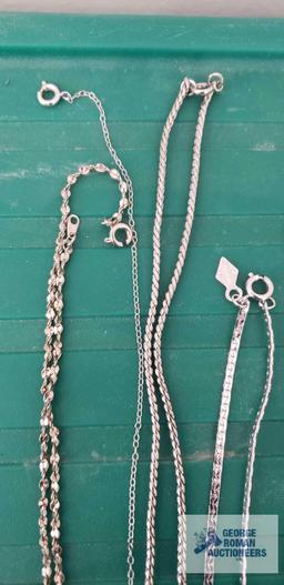 Silver colored costume jewelry necklaces