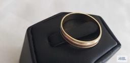 Gold colored band marked 14K, approximate total weight is 2.33 G