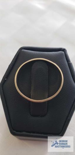 Gold colored band marked 14K, approximate total weight is 2.33 G