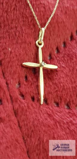 Gold colored cross with clear gemstone chip, marked 14K on gold colored necklace, marked 10K,