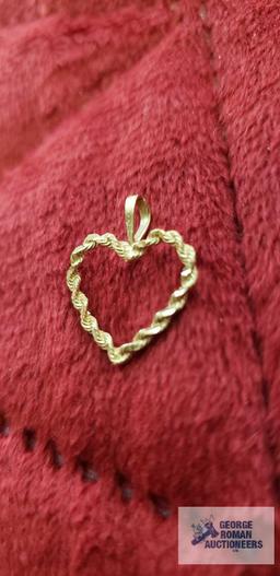 Gold colored heart-shaped pendant, marked 14K, approximate total weight....67 G