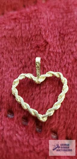 Gold colored heart-shaped pendant, marked 14K, approximate total weight....67 G