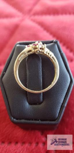 Gold...colored ring with red floral gemstones and clear gemstones on band, marked 14K, missing one r