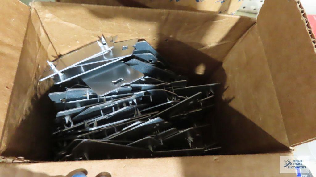 Two boxes of stud plates, staples, screws, nails, etc