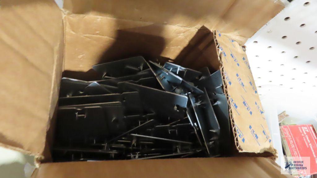 Two boxes of stud plates, staples, screws, nails, etc