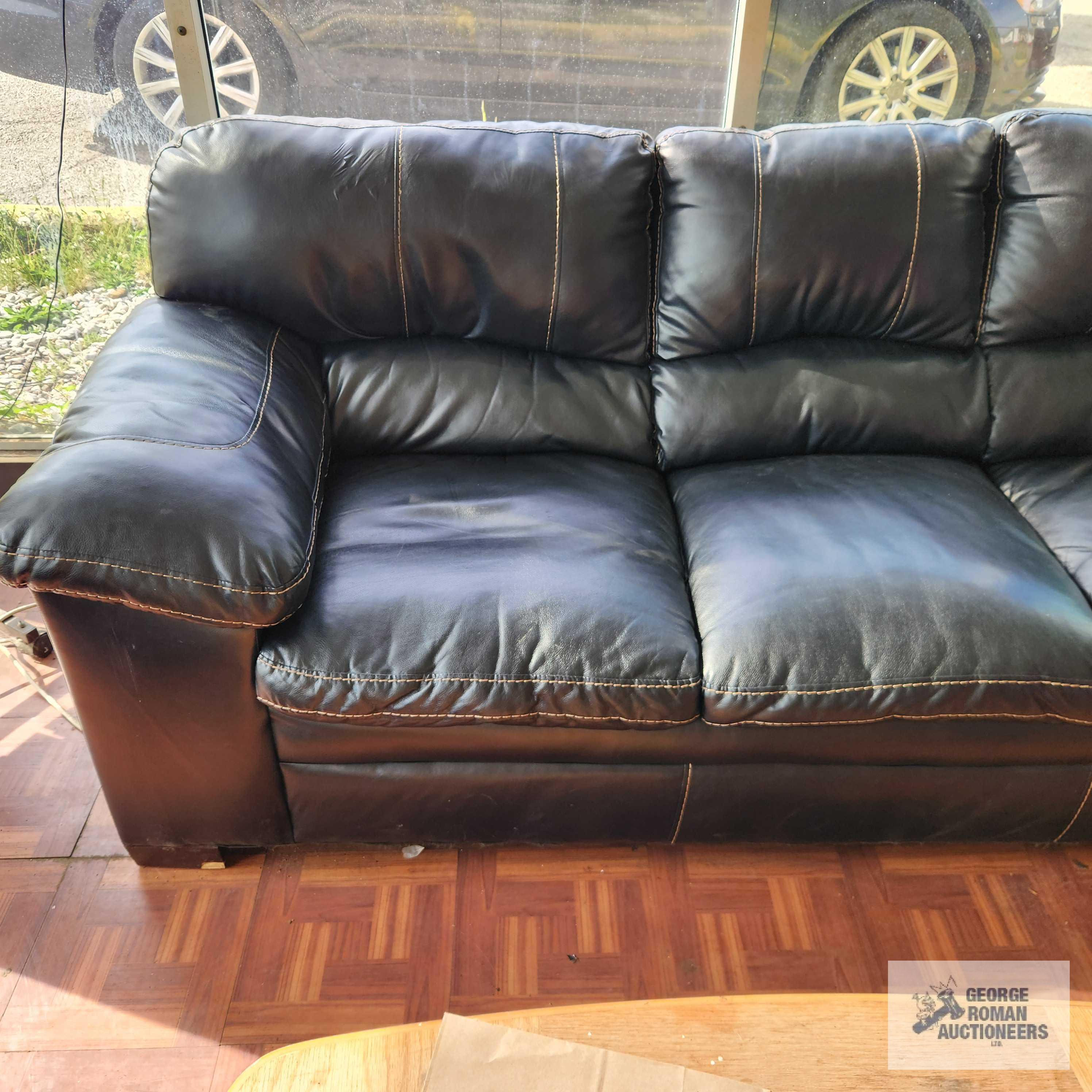 Faux leather sofa, love seat, oak finish coffee table and decorative armchair