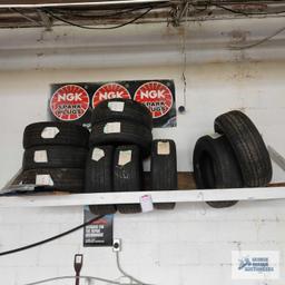 Lot of assorted tires on wooden rack