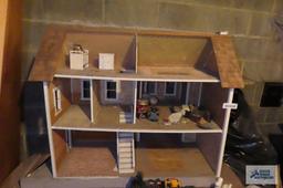 wooden dollhouse in basement