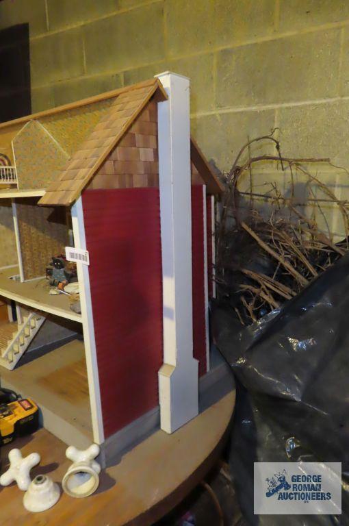 wooden dollhouse in basement