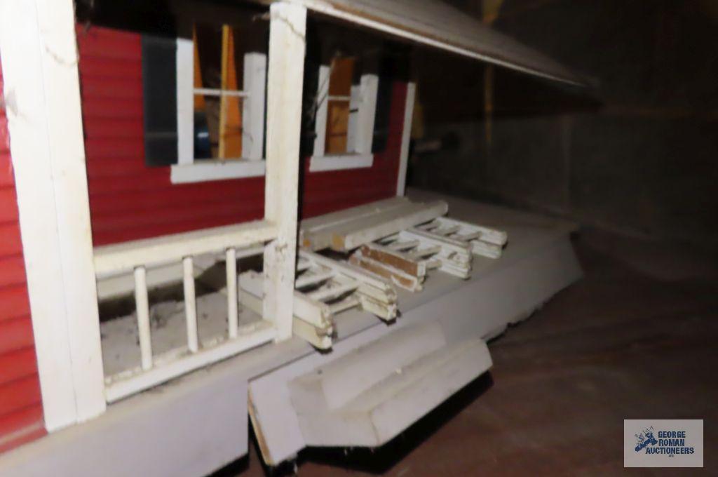 wooden dollhouse in basement