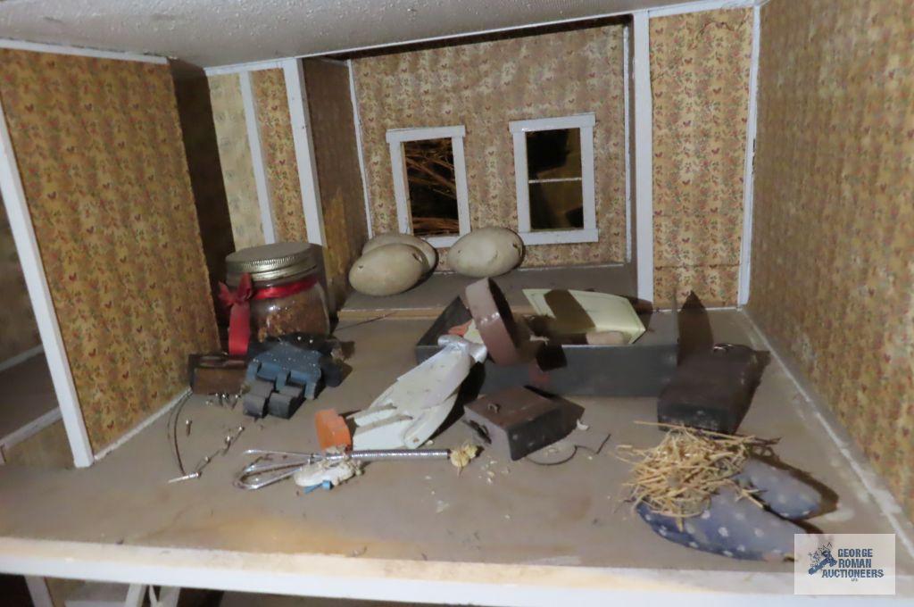 wooden dollhouse in basement